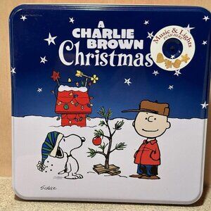 a Charlie brown charismas music & lights collectible cookie tin empty